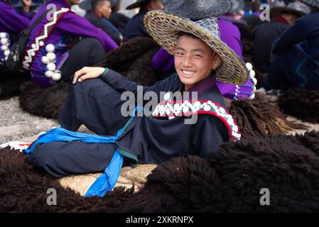 Butuo, province chinoise du Sichuan. 22 juillet 2024. Un garçon vêtu d'un costume traditionnel de Yi participe à la cérémonie d'ouverture de la fête de la flamme dans le comté de Butuo de la préfecture autonome de Liangshan Yi, province du Sichuan, au sud-ouest de la Chine, le 22 juillet 2024. Les résidents en costumes traditionnels du groupe ethnique Yi ont participé à la fête de la flamme de quatre jours qui s'est déroulée du 21 au 24 juillet. Crédit : Jiang Hongjing/Xinhua/Alamy Live News Banque D'Images