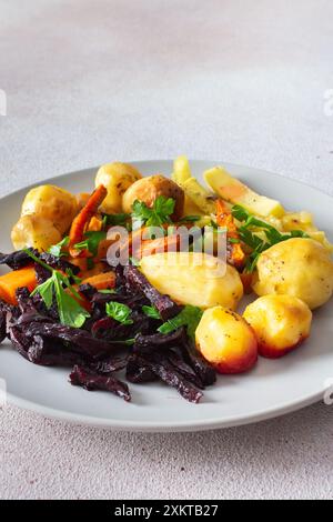 Savourez un repas vibrant et appétissant de légumes cuits au four tels que des pommes de terre, des courgettes, des carottes et des betteraves, idéal pour une pause saine, légère et délicieuse Banque D'Images