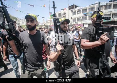 Naplouse, Palestine. 24 juillet 2024. Des hommes armés portent leurs armes lors des funérailles du palestinien Abdel Nasser Sarhan, âgé de 25 ans, dans le camp de réfugiés de Balata, à l'est de la ville de Naplouse, en Cisjordanie occupée. Abdel Nasser Sarhan a été abattu par les forces israéliennes alors qu'il était au sommet de son travail en tant qu'officier dans les douanes palestiniennes. (Photo de Nasser Ishtayeh/SOPA images/Sipa USA) crédit : Sipa USA/Alamy Live News Banque D'Images