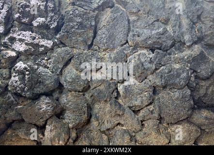 Fond de pierre volcanique noire vue rapprochée Banque D'Images