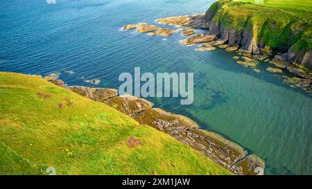 Cullykhan Beach Aberdeenshire Écosse petite crique avec une mer bleu vert entourée de formations rocheuses en été Banque D'Images