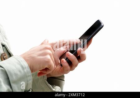 Téléphone portable noir isolé dans les mains d'une femme. Femme touchant l'écran du téléphone portable avec son doigt, gros plan. Banque D'Images