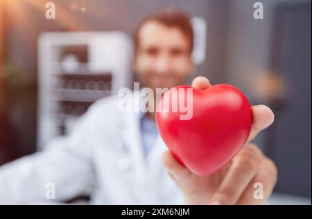 Docteur homme tenant le coeur rouge, concept de cardiologie. Banque D'Images