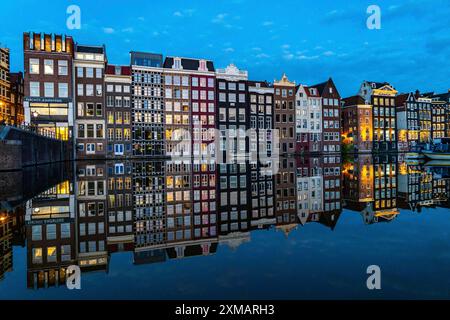 Maisons de canal sur le Damrak, dans le centre de la vieille ville d'Amsterdam, port, point de départ de nombreuses visites du canal, le soir, pays-Bas Banque D'Images