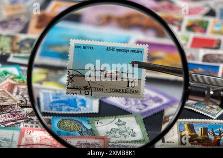 Collection de timbres, collecte, timbres-poste, timbres-poste de différents pays, loupe, timbre avec avion d'Ouzbékistan Banque D'Images