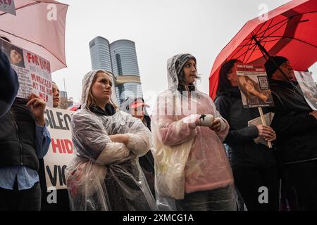 Melbourne, Australie. 27 juillet 2024. Les manifestants ont écouté les discours pendant la manifestation. Malgré la pluie, les gens se sont rassemblés pour protester contre les violences faites aux femmes, après que 54 femmes ont été tuées cette année en raison de violences domestiques, les auteurs de ces violences étant principalement des hommes. Les manifestants appellent le gouvernement australien à agir. Crédit : SOPA images Limited/Alamy Live News Banque D'Images