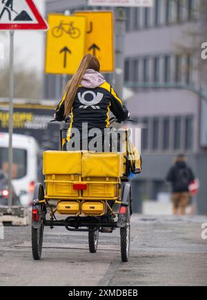 Deutsche Post livreuse sur un tricycle de poste électrique Banque D'Images