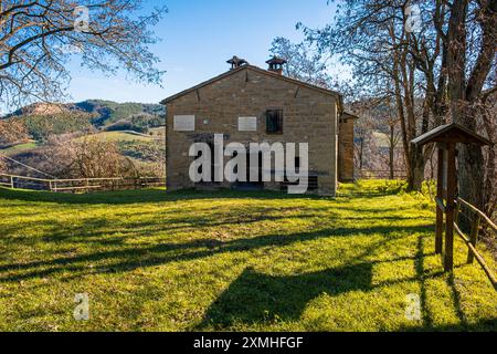 Femme avec sac à dos admirant la vieille maison dans les apennins. CA Cornio, Modigliana, Forlì, Emilie Romagne, Italie, Europe. Banque D'Images