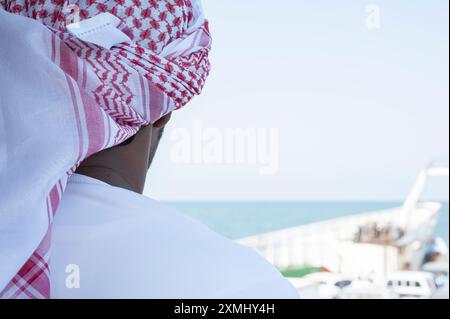 Vue arrière de la tête d'un homme arabe portant un keffiyeh rouge et blanc Banque D'Images