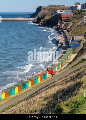 Cabanes de plage colorées sur le front de mer à Whitby Banque D'Images