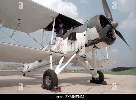 L'ancien pilote John Tupper se tient sur l'aile de son biplan Swordfish , un avion transportant des torpilles principalement transporté à bord des porte-avions britanniques pendant la seconde Guerre mondiale. Il a été conçu dans les années 1930 et construit par la Fairey Aviation Company. 16 août 1996 photo de Roger Bamber Banque D'Images