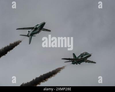 Deux avions de l'équipe d'affichage des Saudi Hawks effectuent une manœuvre de franchissement avec de la fumée au Royal International Air Tattoo 2024 à la RAF Fairford, Banque D'Images