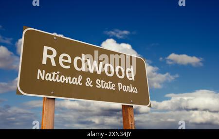 Redwood National and State Parks (Californie) panneau routier contre le ciel bleu et les nuages. Banque D'Images