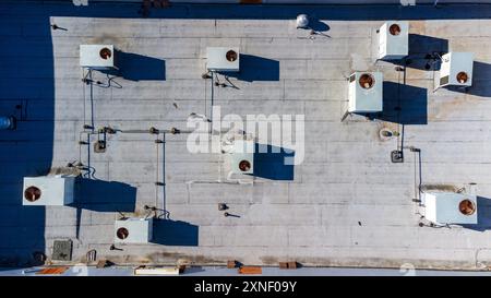 Vue aérienne de haut en bas d'un toit plat d'un bâtiment commercial avec des unités de chauffage, ventilation et climatisation industrielles. Banque D'Images
