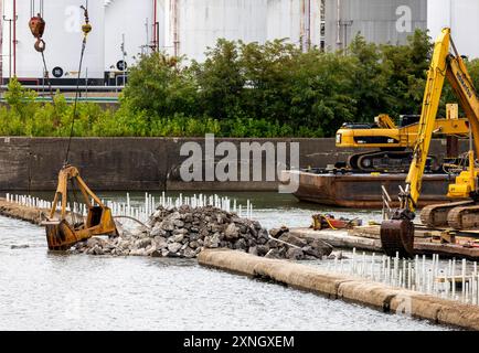 Les entrepreneurs du U.S. Army corps of Engineers District de Pittsburgh utilisent diverses barges flottantes pour forer, démolir et enlever le barrage à crête fixe des écluses de la rivière Monongahela et du barrage 3 à Elizabeth, Pennsylvanie, le 29 juillet 2024. Le district de Pittsburgh a d'abord brisé le barrage à l'aide d'explosifs contrôlés le 10 juillet. Le district, tout en travaillant avec l'entrepreneur, ouvrira un chenal de navigation de 100 pieds de large à travers le barrage existant, rétablissant un tirant d'eau de 9 pieds pour permettre la navigation commerciale à travers le barrage sans utiliser l'écluse. Le district s'est engagé à compléter la channe de 100 pieds Banque D'Images