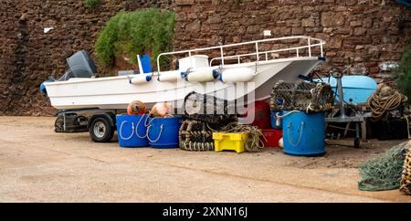 Petit bateau de pêche, casiers à homard, casiers à crabe, pièges à poissons et autres équipements de pêche sur le quai Banque D'Images