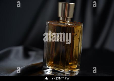 Juin 2024, Jérusalem, Israël : gros plan de bouteille de parfum, unboxed, magie Noire par Lancome : magie noire en bouteille miniature de parfum sur soie sombre Banque D'Images