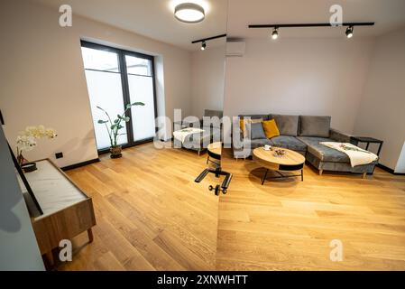 L'intérieur chic et confortable d'un salon moderne avec un canapé élégant et une table basse élégante. Intérieur d'un salon moderne avec canapé et café Banque D'Images