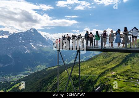 Grindelwald, Suisse - 20 juillet 2024 : les touristes font la queue pour prendre des photos à un point de vue sur la promenade de Grindelwald First Cliff Walk en Suisse Banque D'Images