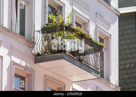 Petit balcon planté avec treillis décoratif en fonte sur un bâtiment résidentiel historique dans la ville, focus sélectionné Banque D'Images