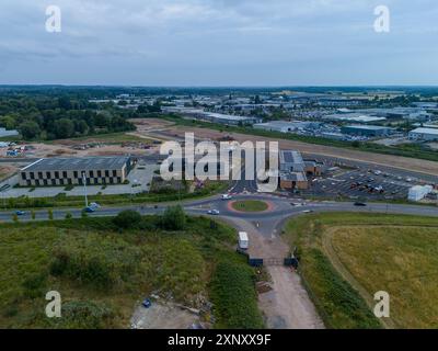 Vue aérienne d'un rond-point et d'une zone industrielle en construction, montrant l'avancement du développement Banque D'Images