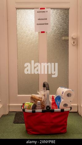 Image symbolique quarantaine domestique, l'homme est en isolement à la maison en raison d'une infection corona suspectée, signe d'avertissement pour les visiteurs sur la porte d'entrée Banque D'Images