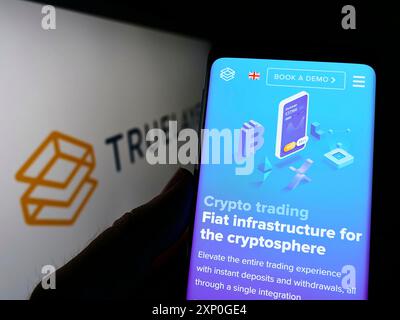 Stuttgart, Allemagne, 05-08-2022 : personne tenant un smartphone avec la page web de la société britannique de fintech TrueLayer Limited sur l'écran devant le logo. Mise au point Banque D'Images