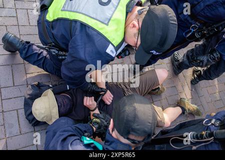 Bristol, Royaume-Uni. 3 août 2024. La police est photographiée alors qu'elle détient un militant anti-racisme lors d'une manifestation pour arrêter le racisme à Castle Park dans le centre de Bristol. Des violences ont éclaté lors de manifestations « assez, c'est assez » dans plusieurs villes anglaises à la suite d'un attentat à l'arme blanche qui a tué trois jeunes filles. La police de Bristol a reçu des pouvoirs supplémentaires pour arrêter, fouiller et disperser les gens afin d'éviter que des troubles éclatent entre le groupe d'extrême droite et les manifestants antiracistes qui ont organisé une contre-manifestation. Crédit : Lynchpics/Alamy Live News Banque D'Images