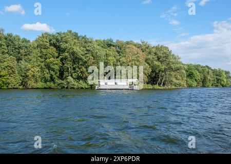 Bateau maison ancré sur un lac d'été à Berlin, Allemagne. Banque D'Images