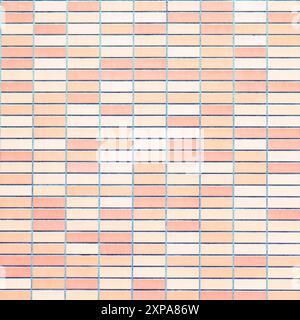 Mur de briques avec des briques de pêche claires et foncées alternées. Composition à plat pour le design et l'impression. Banque D'Images