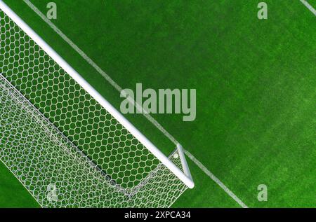 Un angle aérien capture un but de football blanc positionné sur un gazon vert éclatant, soulignant les lignes et la texture du terrain de jeu. Banque D'Images