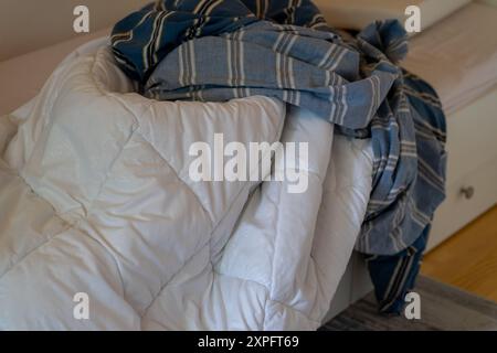 Couverture blanche avec housse de couette sale retirée pour le lavage. Banque D'Images