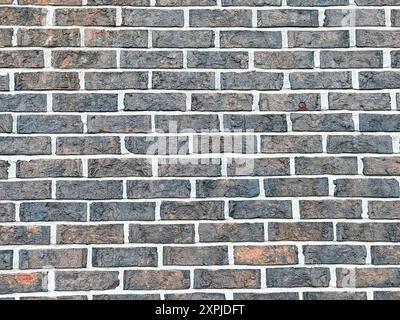 Gros plan du mur de briques grises présentant le motif uniforme et la texture des briques Banque D'Images