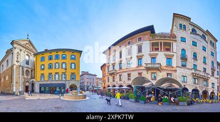 BERGAME, ITALIE - 7 AVRIL 2022 : Panorama de Largo Nicolo Rezzara avec des maisons de ville historiques colorées et fresques et l'église de San Leonardo, Citta Bassa Banque D'Images