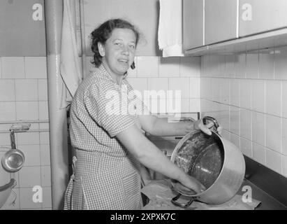 Current 1948 : femmes qui dirigent des doubles livesfemmes qui travaillent à double emploi. Elles participent à la vie professionnelle et sont aussi des ménagères. Mme Marie Wilhelmsen nettoie quotidiennement au 13-14 bureau. Elle est en plein essor de cinq heures et demie du matin (je suis debout à quatre heures et demie!) et doivent se dépêcher à la maison à sa fille de quatre ans, qui est seule à la maison de son père va travailler à sept heures et demie jusqu'à ce que la mère rentre à la maison à neuf heures trente. Son homme rentre à la maison pour le dîner à cinq heures, et une heure après qu'elle a mis sa fille au lit, se laisse au lit à huit heures et demie. Mme Wilhelmsen h Banque D'Images