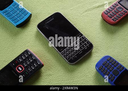 Terengganu, Malaysia - 24 August 2024 : Closeup of nokia and blackberry keypad phones on green background Stock Photo