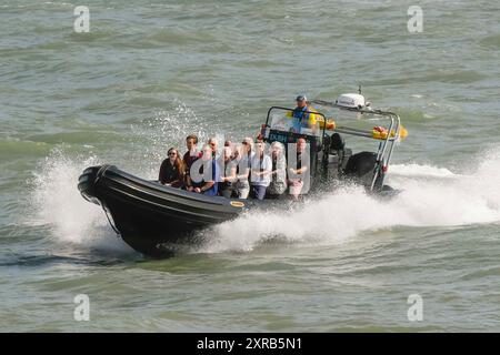 West Bay, Dorset, Royaume-Uni. 9 août 2024. Météo britannique. Les vacanciers s'amusant sur la mer sur un bateau charter RIB de Lyme Bay comme ils profitent d'un voyage dans le soleil brûlant de l'après-midi à la station balnéaire de West Bay dans le Dorset. Crédit photo : Graham Hunt/Alamy Live News Banque D'Images