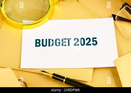 Symbole du budget conceptuel 2025. Copier l'espace. Budget de 2025 mots écrits sur une carte d'affaires blanche posée sur des enveloppes postales Banque D'Images