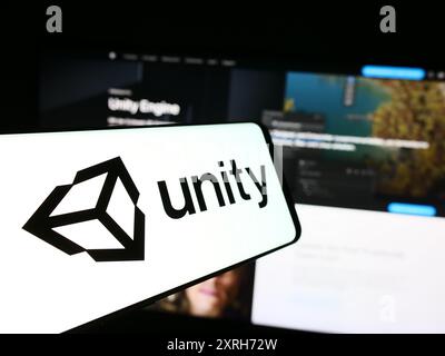 Téléphone portable avec le logo de la société américaine de jeux vidéo Unity Software Inc devant le site Web de l'entreprise. Mettez l'accent sur le centre-gauche de l'écran du téléphone. Banque D'Images