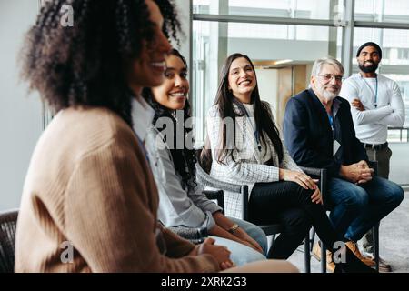 Groupe multiethnique de collègues réseautant, riant et profitant d'une réunion d'affaires informelle ensemble. Banque D'Images