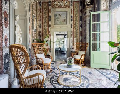 Maison élégante à Florence, détail du salon dans une serre donnant sur le jardin. Les murs décorés de pierres antiques et d'une statue. Banque D'Images