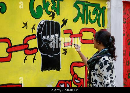 Des élèves peignent un nouveau graffiti sur un mur de rue à Dhaka, au Bangladesh. 10 août 2024. Dans un discours à la nation, le chef d'état-major de l'armée, le général Waker-UZ-Zaman, a annoncé le 5 août 2024 la démission du premier ministre Sheikh Hasina après des semaines de troubles. Photo de Suvra Kanti Das/ABACAPRESS. COM Credit : Abaca Press/Alamy Live News Banque D'Images