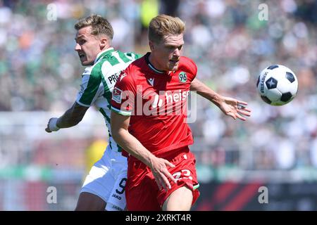 Fussball 2. Bundesliga 2. Spieltag SC Preussen Muenster - Hannover 96 AM 11.08.2024 im Preussenstadion in Muenster Marcel Halstenberg ( Hannover ), vorne - Joel Grodowski ( Muenster ), hinten la réglementation DFL interdit toute utilisation de photographies comme séquences d'images et/ou quasi-vidéo. Foto : Revierfoto Banque D'Images