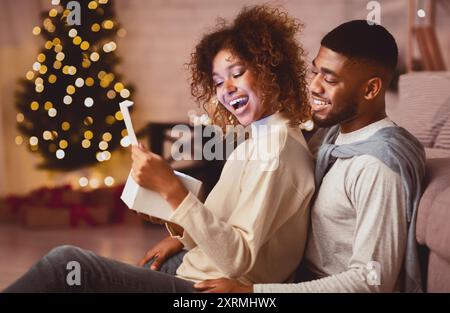 Heureux couple afro-américains à la maison cadeaux de Noël Banque D'Images