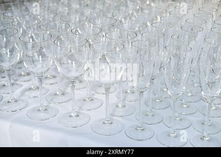 Gros plan de nombreux verres à vin vides sur une table. Plats dans le restaurant pour la réception des invités et une fête alcoolisée. Beaucoup de champagne gl propre Banque D'Images