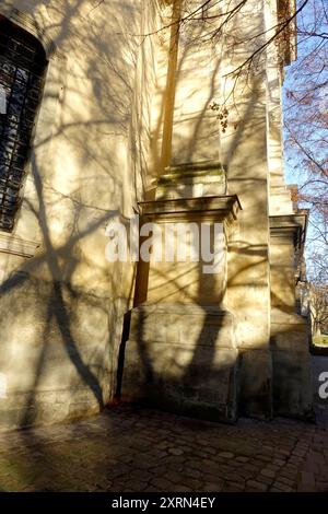 La lumière du soleil crée des ombres complexes sur les fondations de la cathédrale médiévale dominicaine de Lviv, révélant des détails architecturaux. Banque D'Images