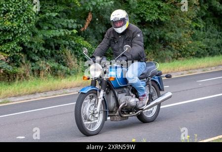 Potterspury, Northants, Royaume-Uni - 11 août 2024 : 1976 moto BMW bleue voyageant sur une route britannique Banque D'Images