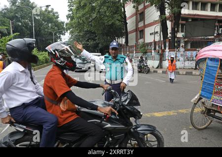 Dhaka, Bangladesh. 12 août 2024. Le personnel de police contrôle la circulation à un carrefour routier après que la police bangladaise a repris ses fonctions, à Dhaka le 12 août 2024. La police bangladaise a repris lundi les patrouilles dans la capitale Dhaka, mettant fin à une grève d'une semaine qui a laissé un vide juridique et de l'ordre après l'éviction brutale de l'ancien premier ministre autocratique Sheikh Hasina photo de Habibur Rahman/ABACAPRESS. COM Credit : Abaca Press/Alamy Live News Banque D'Images