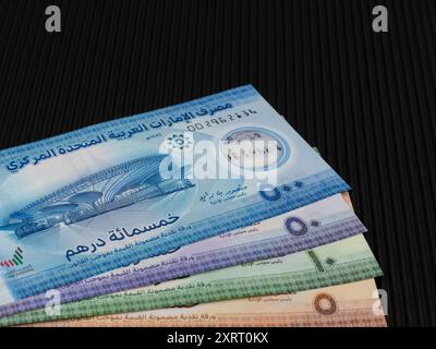 Billets de banque neufs en plastique de l'Émirat de 5, 10, 50 et 500 dirhams sur fond noir Banque D'Images