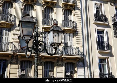 Lampadaire contre le contour d'un bâtiment de style architectural typique, Avenue Auber, Nice, France. Banque D'Images